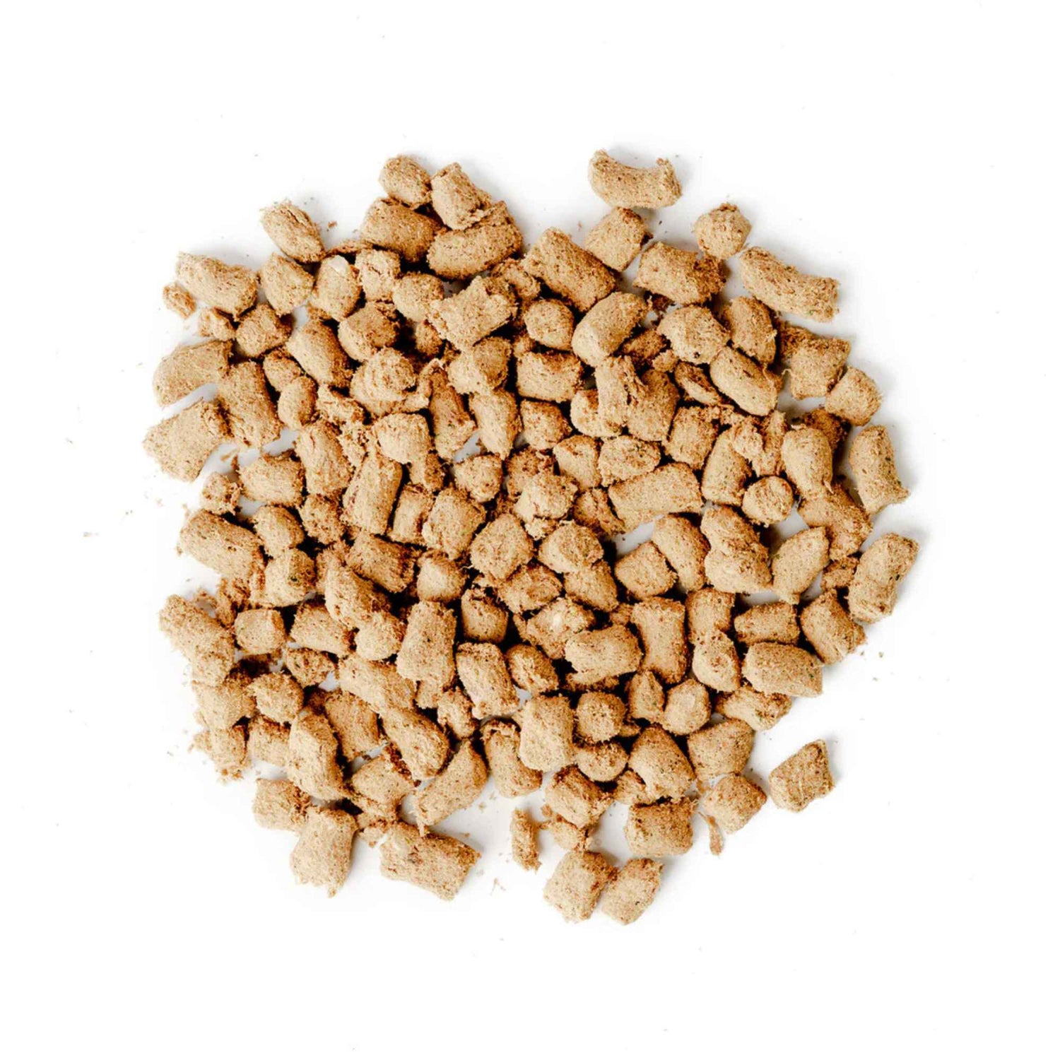 Pile of green juju turkey and sardine freeze dried raw food pieces on a white background