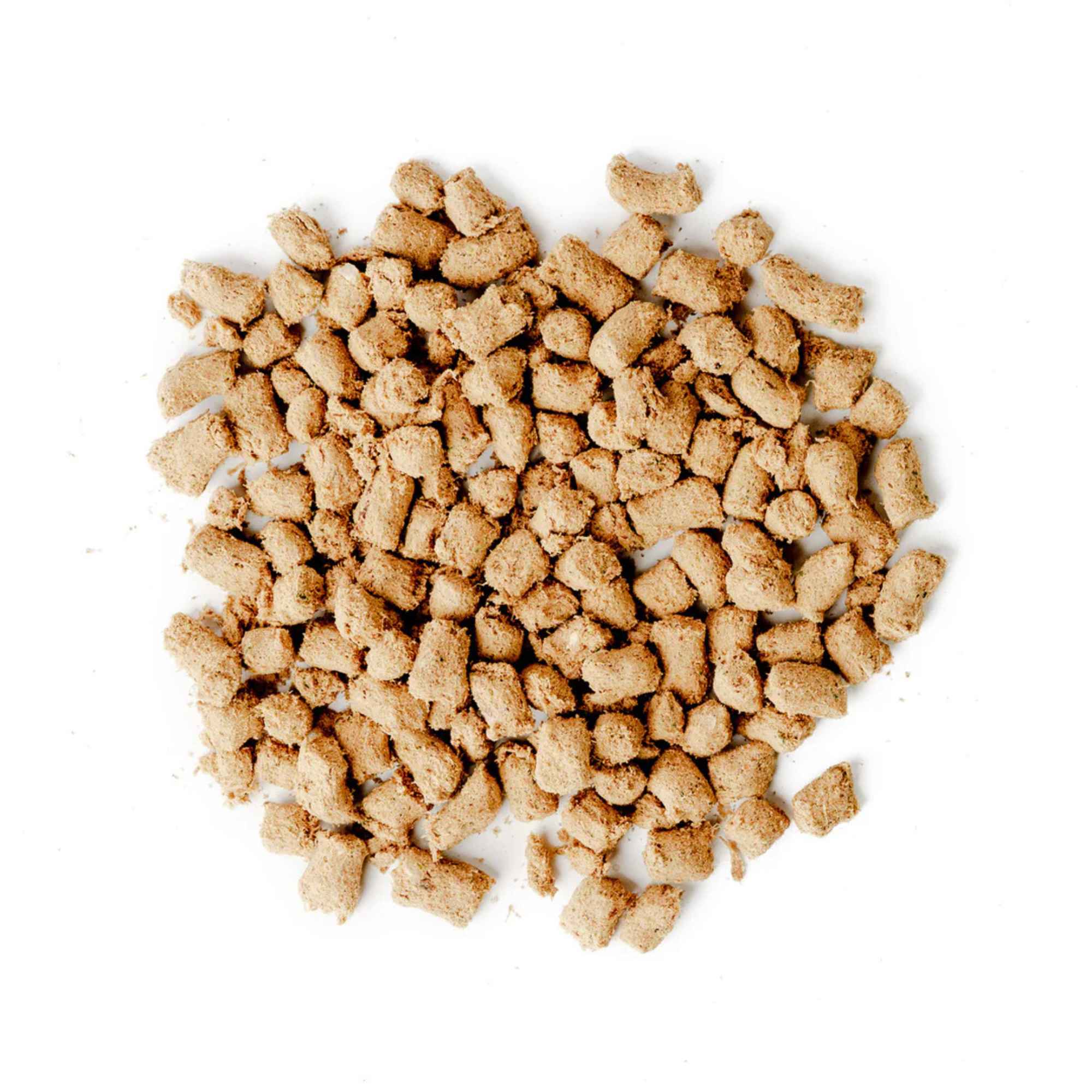 Pile of green juju turkey and sardine freeze dried raw food pieces on a white background